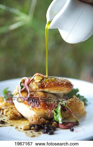 Stock Photo - Hawaii, Olive Oil Being Poured Over Delicious Chicken Dish.. Fotosearch