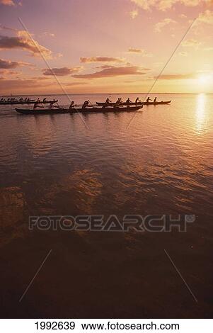 Stock Photo - Hawaii, Outrigger Canoe And Paddlers Silhouetted, Pink Sunset And Ocean Reflections. Fotosearch