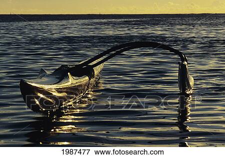 Stock Photo - Hawaii, Outrigger Canoe, Rippled Ocean Water And Dramatic Reflections In Afternoon Light.. Fotosearch