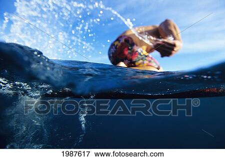 Hawaii, Over/Under View Of Man Paddleboarding. View Large Photo Image Stock Photo - Hawaii, Over/Under View Of Man Paddleboarding.. Fotosearch