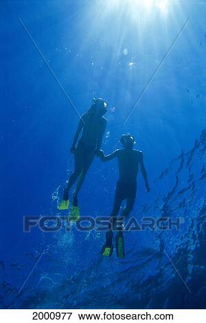 Hawaii, Pacific Ocean View From Beneath Couple Snorkel At Surface, Sunburst Sunrays View Large Photo Image Stock Photo - Hawaii, Pacific Ocean View From Beneath Couple Snorkel At Surface, Sunburst Sunrays. Fotosearch