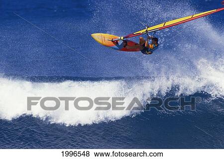 Stock Photo - Hawaii, Pete Cabrina Jumps Wave, Windsurfing Contest. Fotosearch