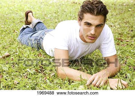 Hawaii, Portrait Of A European Male Model Laying On Grass. View Large Photo Image Stock Photo - Hawaii, Portrait Of A European Male Model Laying On Grass.. Fotosearch