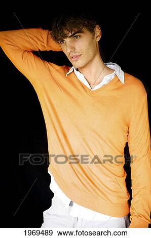 Stock Photo - Hawaii, Portrait Of A European Male Model In Orange Sweater.. Fotosearch