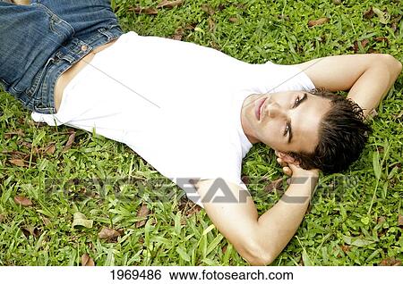 Hawaii, Portrait Of A European Male Model Laying On Grass. View Large Photo Image Stock Photograph - Hawaii, Portrait Of A European Male Model Laying On Grass.. Fotosearch