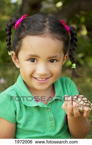 Hawaii, Portrait Of Young Girl Holding Small Tortoise In Hand. View Large Photo Image Stock Photograph - Hawaii, Portrait Of Young Girl Holding Small Tortoise In Hand.. Fotosearch