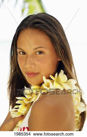 Picture - Hawaii, Portrait Shot Of A Teenage Girl Wearing A Yellow Plumeria Lei.. Fotosearch