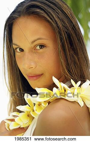 Hawaii, Portrait Shot Of A Teenage Girl Wearing A Yellow Plumeria Lei. View Large Photo Image Stock Image - Hawaii, Portrait Shot Of A Teenage Girl Wearing A Yellow Plumeria Lei.. Fotosearch