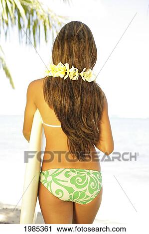 Hawaii, Portrait Shot Of A Teenage Surfer Girl From Behind, Wearing A Yellow Plumeria Lei, Holding A Surfboard. View Large Photo Image Stock Image - Hawaii, Portrait Shot Of A Teenage Surfer Girl From Behind, Wearing A Yellow Plumeria Lei, Holding A Surfboard.. Fotosearch