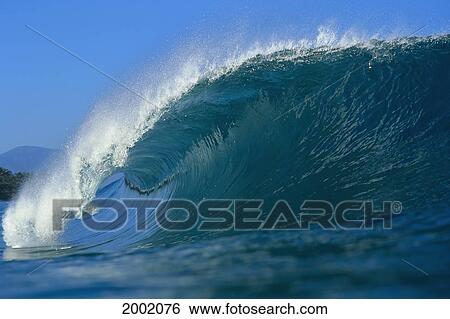 Stock Photograph - Hawaii, Powerful Wave Curling With Blue Skies In Background. Fotosearch