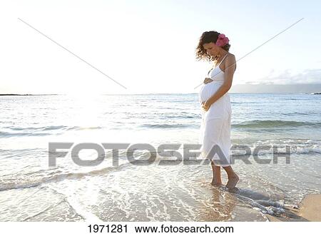 Stock Image - Hawaii, Pregnant Woman On Tropical Beach.. Fotosearch