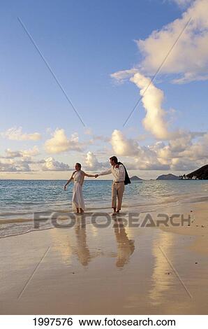 Hawaii, Romantic Couple Walk Along Shoreline At Sunset View Large Photo Image Stock Photograph - Hawaii, Romantic Couple Walk Along Shoreline At Sunset. Fotosearch