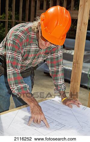 Hawaii, Senior male construction worker reading blueprints at a construction site. View Large Photo Image Stock Image - Hawaii, Senior male construction worker reading blueprints at a construction site.. Fotosearch