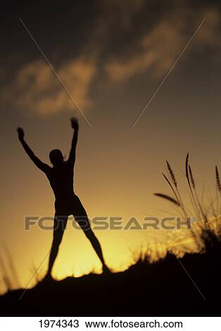 Hawaii, Silhouette Of A Woman Stretching On A Mountain Top At Sunset. View Large Photo Image Stock Image - Hawaii, Silhouette Of A Woman Stretching On A Mountain Top At Sunset.. Fotosearch