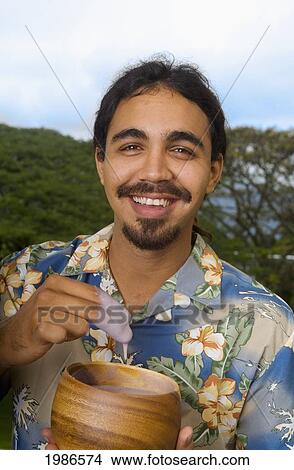 Picture - Hawaii, Smiling Local Man Eating Poi With Fingers Out Of Wooden Bowl.. Fotosearch
