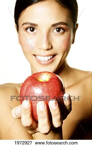 Hawaii, Studio Headshot Of A Beautiful Girl Holding An Apple. View Large Photo Image Stock Photo - Hawaii, Studio Headshot Of A Beautiful Girl Holding An Apple.. Fotosearch