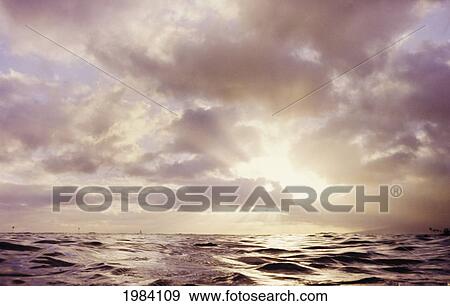 Hawaii, Sunset Over Choppy Ocean, Beautiful Sun Rays Bursting Through Cloudy Sky. View Large Photo Image Stock Photo - Hawaii, Sunset Over Choppy Ocean, Beautiful Sun Rays Bursting Through Cloudy Sky.. Fotosearch