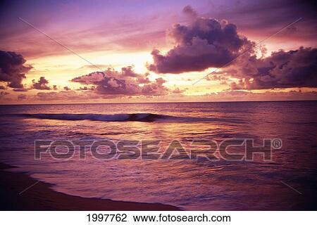 Stock Image - Hawaii, Sunset Over Ocean With Tiny Wave, Tropical Scenic Reflections A32E. Fotosearch