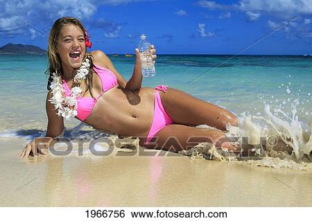 Stock Photograph - Hawaii, Teenage Girl On Beach With Bottle Of Water.. Fotosearch