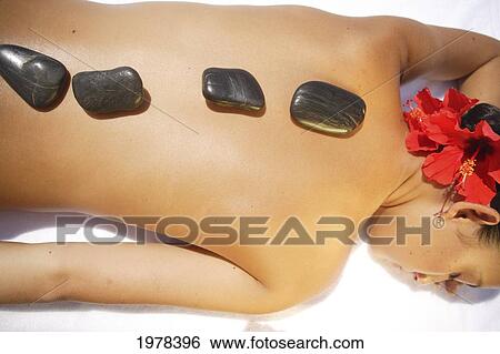 Hawaii, Topless Girl With Stones Laid Upon Her Back, Laying Down To Receive Massage. View Large Photo Image Stock Photograph - Hawaii, Topless Girl With Stones Laid Upon Her Back, Laying Down To Receive Massage.. Fotosearch