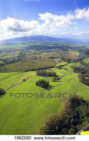 Stock Image - Hawaii. USA, aerial view; Maui, Scenic landscape of meadows of Haleakala Ranch and West Maui Mountains. Fotosearch