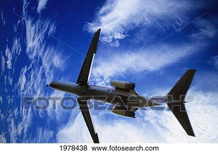 Stock Photo - Hawaii, View From Below Of Airplane Taking Off Into Bright Blue Sky.. Fotosearch