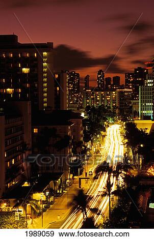 Hawaii, Waikiki, Overview Of Palm Lined Kalakaua Avenue Lit Up At Dusk View Large Photo Image Stock Photo - Hawaii, Waikiki, Overview Of Palm Lined Kalakaua Avenue Lit Up At Dusk. Fotosearch