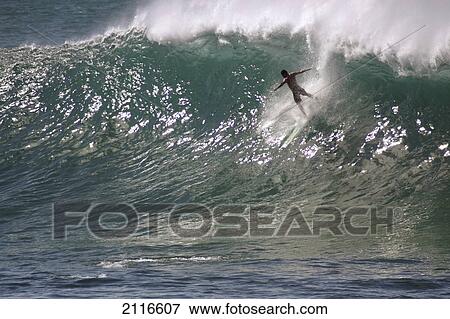 Stock Photo - Hawaii, Waimea Bay, man surfing a large wave.. Fotosearch