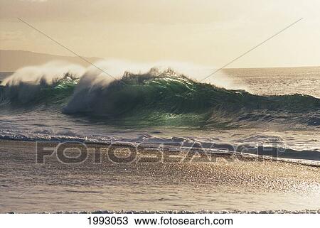 Stock Image - Hawaii, Waves Shimmer With Silvery Light.. Fotosearch