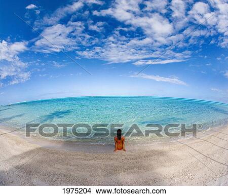 Picture - Hawaii, Woman Laying On The Beach In Remote Tropical Location.. Fotosearch