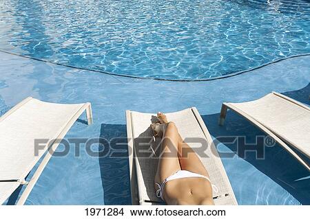 Hawaii, Woman Lounging At Hotel Poolside, Legs And Midriff. View Large Photo Image Picture - Hawaii, Woman Lounging At Hotel Poolside, Legs And Midriff.. Fotosearch