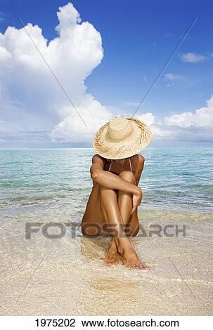 Hawaii, Woman Sitting In The Ocean At A Remote Tropical Location. View Large Photo Image Stock Image - Hawaii, Woman Sitting In The Ocean At A Remote Tropical Location.. Fotosearch