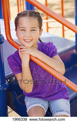 Hawaii, Young Girl Sitting On Jungle Gym Steps In The Park. View Large Photo Image Stock Photo - Hawaii, Young Girl Sitting On Jungle Gym Steps In The Park.. Fotosearch