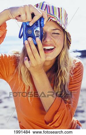 Picture - Hawaii, Young Woman Taking Picture At The Beach. Fotosearch