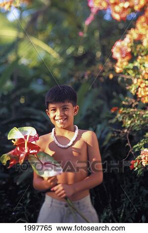 Stock Photography - Hawaiian Boy With Puka Necklace Holding Anthurium Lush Jungle Background. Fotosearch