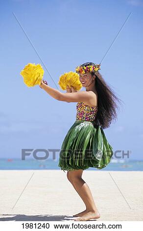 Stock Image - Hawaiian Woman Dancing Hula On White Sand Beach.. Fotosearch