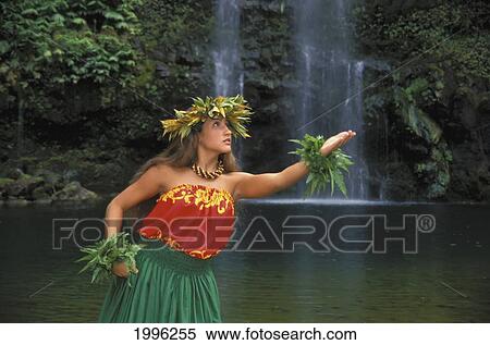 Stock Photography - Hawaiian Woman Wearing Hula Attire, Waterfall Background, With Haku. Fotosearch