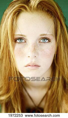 Stock Image - Head Shot Of A Young Woman With Red Hair And Freckles.. Fotosearch