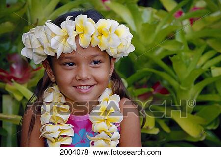 Stock Photo - Headshot Of Smiling Local Girl Wearing Plumeria Haku And Lei, Outdoor Greenery Background. Fotosearch
