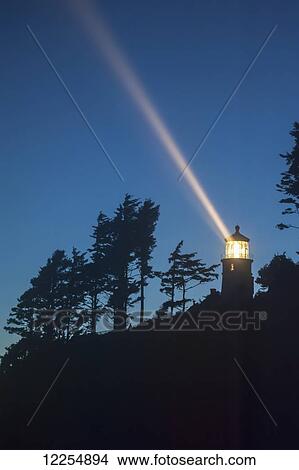 Picture - Heceta Head lighthouse shining through the oncoming darkness; Oregon, United States of America. Fotosearch