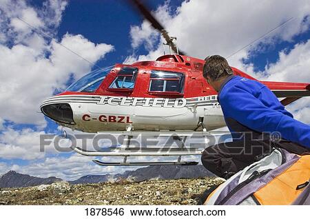 Stock Photograph - Helicopter Dropping Off Tourist At Columbia Icefield.. Fotosearch