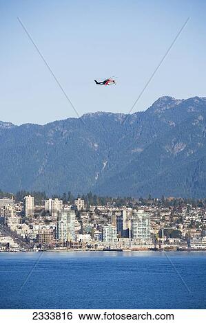 Helicopter Flying Over City, Vancouver Waterfront, Harbor; Vancouver, British Columbia, Canada View Large Photo Image Stock Photograph - Helicopter Flying Over City, Vancouver Waterfront, Harbor; Vancouver, British Columbia, Canada. Fotosearch