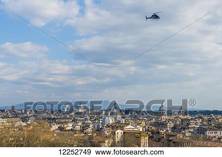 Stock Photo - Helicopter in the sky above Rome; Rome, Lazio, Italy. Fotosearch