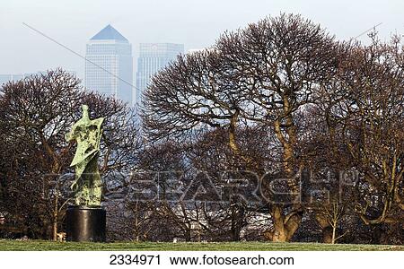 Stock Image - Henry Moore Statue And Canary Wharf From Greenwich Park; Greenwich, London, England, Uk. Fotosearch