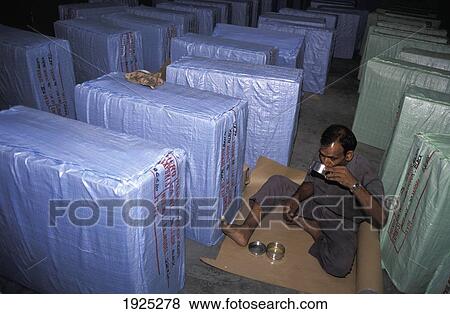 Hero Cycles / Worker Eating By Boxes Of New Bikes, Ludhiana View Large Photo Image Stock Photo - Hero Cycles / Worker Eating By Boxes Of New Bikes, Ludhiana. Fotosearch