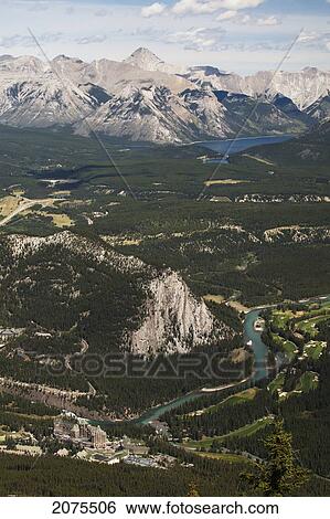 Stock Photograph - High Angle Of Bow River Valley With Banff Springs Golf Course Banff Springs Hotel Mountains And Lake In The Distance; Banff Alberta Canada. Fotosearch