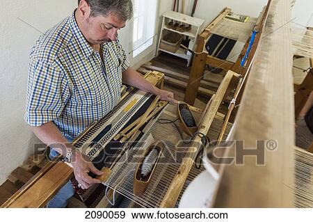 Stock Photo - High Angle View Of A Man Working On Loom Demonstration At Ortega's Weaving Shop, New Mexico, Usa. Fotosearch