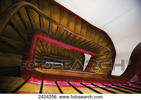 Stock Photograph - High angle view of a wooden steps, handrail and railing inside a building, Marais district; Paris, France. Fotosearch
