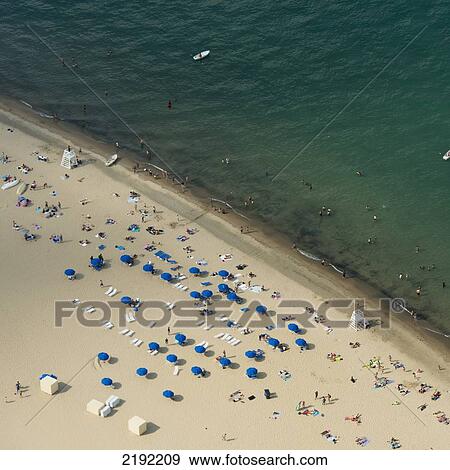 Stock Photo - High Angle View Of Chairs And Umbrellas On The Beach Along Lake Michigan; Chicago Illinois United States Of America. Fotosearch