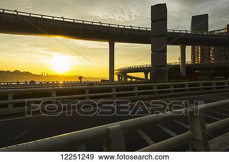 Highway from Xiamen city, China at sunset, with Gulangyu island in the background; Xiamen, China View Large Photo Image Stock Photo - Highway from Xiamen city, China at sunset, with Gulangyu island in the background; Xiamen, China. Fotosearch